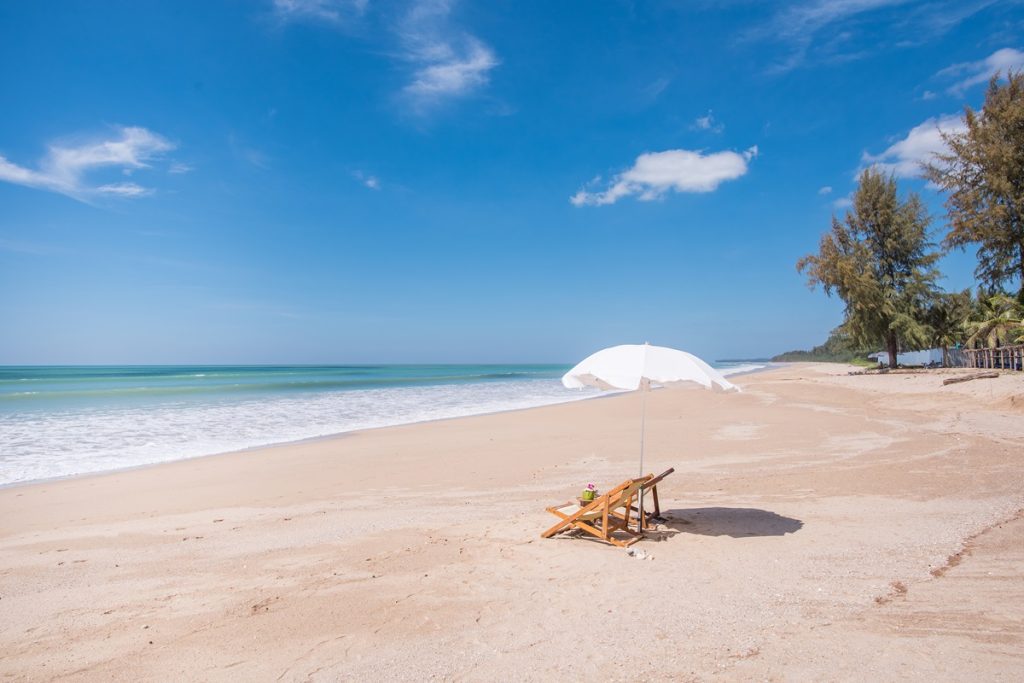Secluded private Beach with deck chairs and an umbrella